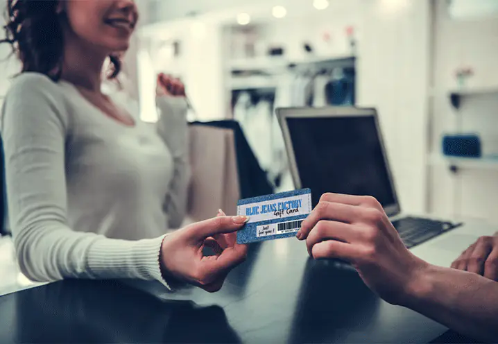 woman holding plastic card