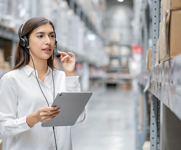 Warehouse woman using digital tablet checking stock